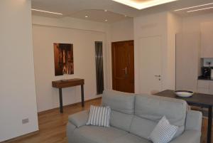 a living room with a couch and a table at Vittori Apartment in Siena