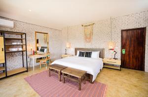 a bedroom with a large bed and a large window at Selina Montañita in Montañita