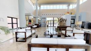 a living room with white couches and tables at Leo Punta Umbría in Punta Umbría
