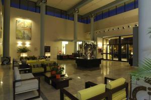a lobby with couches and chairs in a building at Leo Punta Umbría in Punta Umbría
