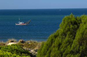 a boat floating in the water on the ocean at Leo Punta Umbría in Punta Umbría