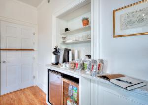 a kitchen with a counter with a refrigerator at The Water Street Inn in Kittery