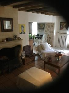 a living room with a couch and a fireplace at Maison de Sandrine in Jumeauville