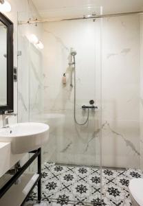 a bathroom with a shower and a sink at Moja apartments in Krakow