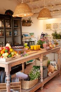 a table filled with lots of fruits and vegetables at Arkhé Hotel Boutique Pals in Pals