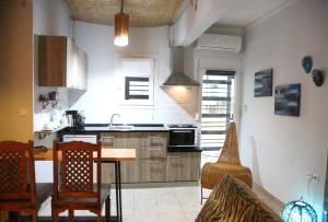 a kitchen with a table and chairs in a room at ZEN Apartment in Serres