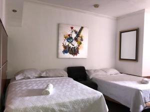 Ένα ή περισσότερα κρεβάτια σε δωμάτιο στο Hotel Costa Inn