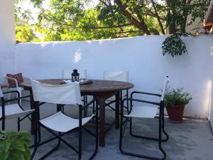 a wooden table and chairs on a patio at Traditional Detached House in Spetses