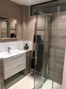 une salle de bain avec un lavabo et une douche dans l'établissement L'Escale Sètoise, à Sète
