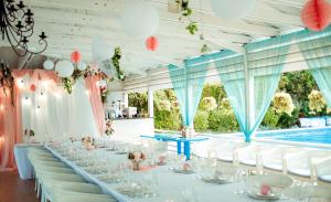 a table set up for a wedding with a pool in the background at Villa Santorini in Zatoka +87 photos