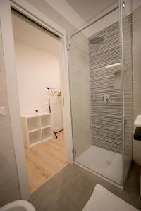 a bathroom with a shower with a glass door at B&B IL GROTTINO in Modugno