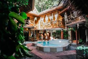 a house with a pool in the middle of a courtyard at Natura Vista in Panglao Island