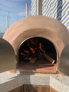 a brick oven with a fire inside of it at Casa Paracas in Paracas