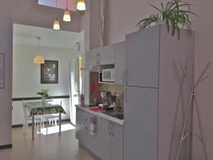 a kitchen with a white refrigerator and a table at Appartamenti Borghetto Panigale in Bologna