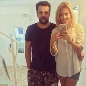 a man and a woman taking a picture in a mirror at Hotel Tritone Rimini in Rimini