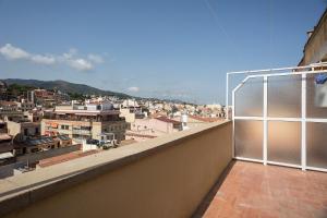 a balcony with a view of a city at Pis Ocata in El Masnou