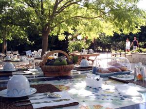 uma mesa com pratos e um cesto de fruta em B&B Villa Giuliana em Arnesano