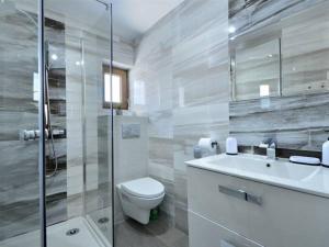 a bathroom with a toilet and a sink and a shower at Miłe Zacisze in Karpacz +26 photos