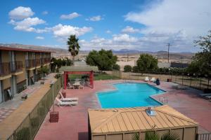 a view of a swimming pool in a resort at California Inn Barstow in Barstow