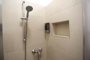 a shower with a shower head in a bathroom at DB Apartments - Dabasso in Mestre