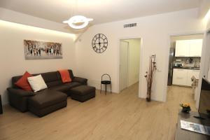 a living room with a couch and a table at DB Apartments - Dabasso in Mestre +17 photos