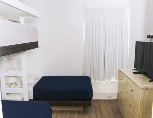 Cama ou camas em um quarto em Casa Paracas