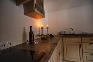 a kitchen with a counter with two candles and two wine glasses at Fewo Froschkönig in Schieder-Schwalenberg