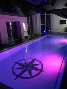 a swimming pool with a peace sign on the floor at Browns in Peterhead