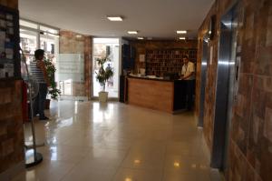 a lobby of a store with people standing at a counter at Stgo centro, Departamentos Amoblados Paz in Santiago +23 photos