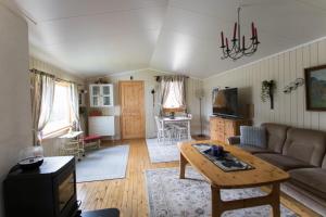 a living room with a couch and a table at Midt Troms Perle in Finnsnes