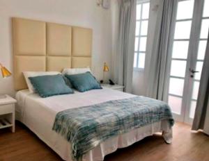 Cama ou camas em um quarto em Casa Paracas
