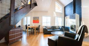 a living room with a staircase in a house at Lapland Dream Villas in Rauhala