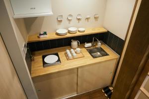 a small kitchen with a sink and a counter at Machizukitei in Kyoto