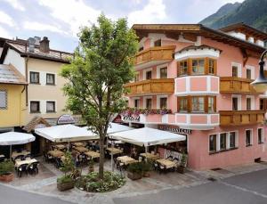 a building with tables and chairs in front of it at Dependance Central in Ischgl