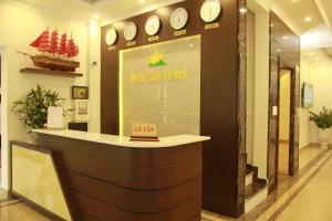 a counter in a store with clocks on the wall at New Sun Hotel in Ha Long