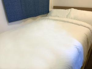 מיטה או מיטות בחדר ב-The Cove Hostel - Tong Fuk Octopus