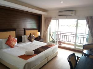 a bedroom with a large bed and a balcony at Seaside Jomtien Beach Pattaya in Jomtien Beach +28 photos