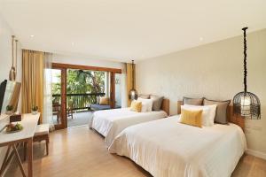 a hotel room with two beds and a balcony at Bandara Spa Resort & Pool Villas, Samui in Bophut