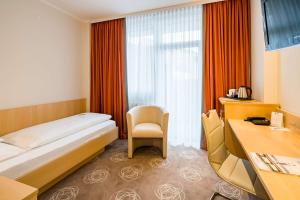 Tempat tidur dalam kamar di Best Western City Hotel Braunschweig