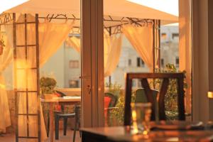 a patio with a table and an umbrella at Giljana ensuite rooms shared terrace & kitchen in St. Julianʼs