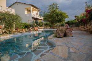 a swimming pool in front of a house at Kamili View Apartments in Kiwengwa