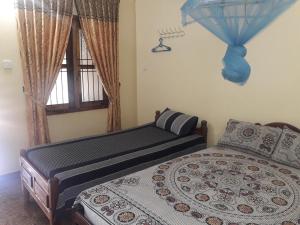 Кровать или кровати в номере Naaval Beach Villa & Rooms