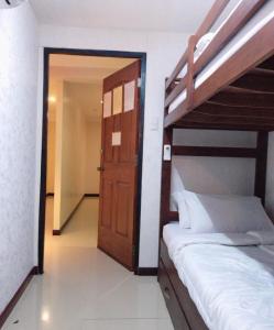 a bedroom with a bunk bed and a open door at Blue Paseo Grande Inn in Naga