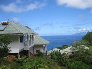Glacis切普斯德小木屋酒店的山上的房子，背景是大海