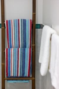 a towel rack with a colorful striped towel at Te Ava Beach Villas in Rarotonga