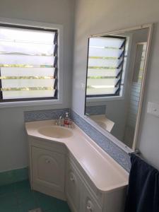 a bathroom with a sink and a mirror at LOUISA in Townsville