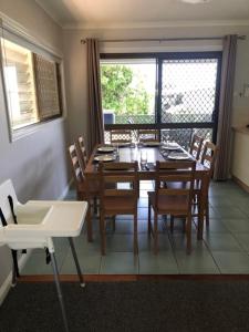 a dining room with a table and chairs and a window at LOUISA in Townsville