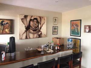 a bar in a restaurant with a picture of a woman at Crocodile Bend in Mpakeni