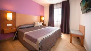 a hotel room with a bed and a window at Leo Punta Umbría - Adults Only in Punta Umbría +31 photos