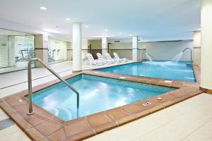 a lap pool in a hotel room with chairs at Grupotel Maritimo in Port d'Alcudia